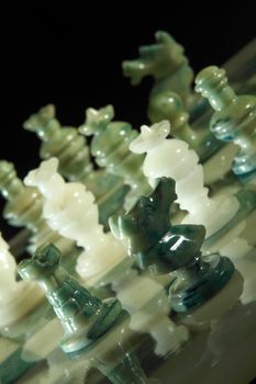 chessboard and alabaster chess on a black background