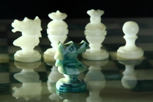 chessboard and alabaster chess on a black background