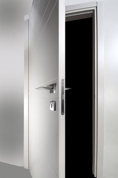 white wooden door open on black background
