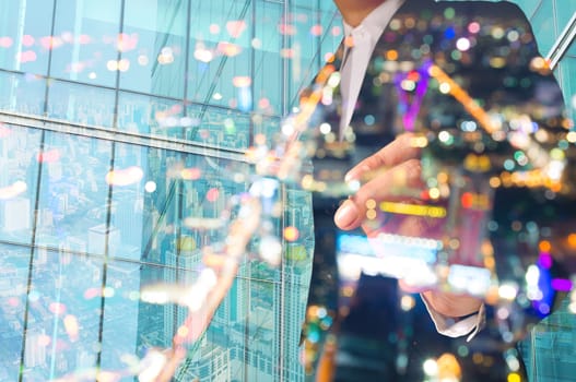 Double Exposure of Businessman draw Something with City Scene and Glass decorated Building