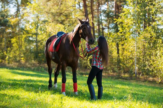 beautiful long hair young woman with a horse outdoor