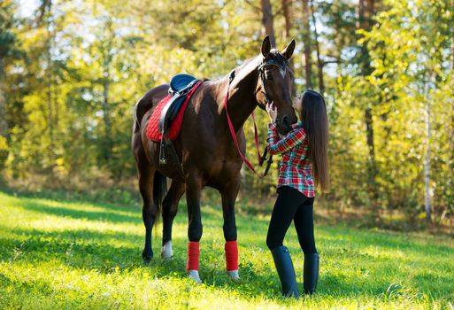 beautiful long hair young woman with a horse outdoor