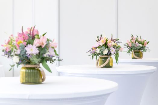 a beautiful flower arrangement on white festive tables