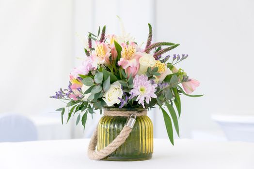 a beautiful flower arrangement on white festive table