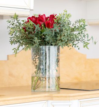 the beautiful flower arrangement in clear glass vase