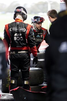 MELBOURNE/AUSTRALIA - SEPTEMBER 17, 2016: Team engineers hard at work at the Wilson Security Sandown 500 'Retro' Endurance race at Sandown raceway.