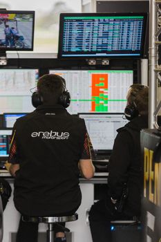 MELBOURNE/AUSTRALIA - SEPTEMBER 17, 2016: Team engineers hard at work at the Wilson Security Sandown 500 'Retro' Endurance race at Sandown raceway.