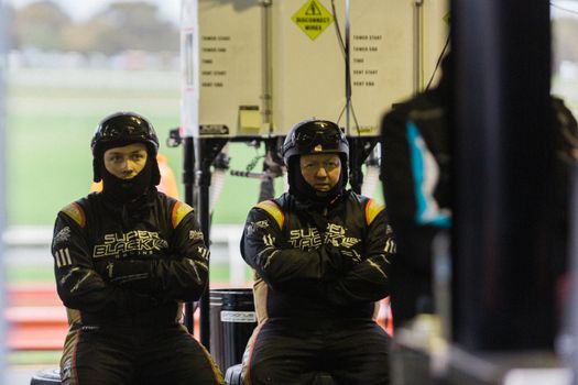 MELBOURNE/AUSTRALIA - SEPTEMBER 17, 2016: Team engineers hard at work at the Wilson Security Sandown 500 'Retro' Endurance race at Sandown raceway.