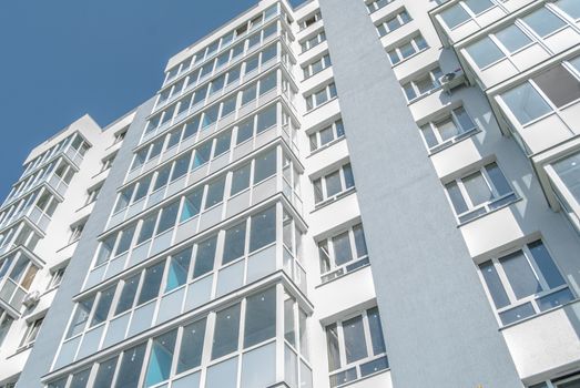 kind of new multistory residential building decorated in grey colors in sunny day