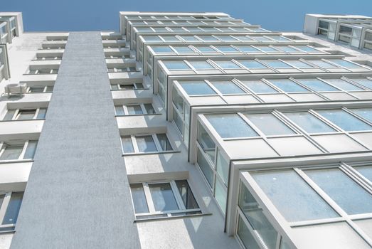 kind of new multistory residential building decorated in grey colors in sunny day