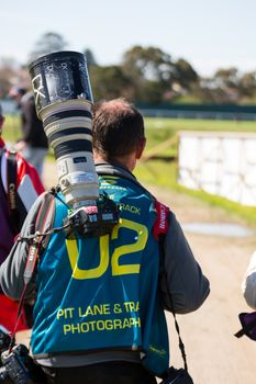 MELBOURNE/AUSTRALIA - SEPTEMBER 17, 2016: One of the fantastic professional photographers working trackside for the Sandown 500 'Retro' Endurance race at Sandown raceway.