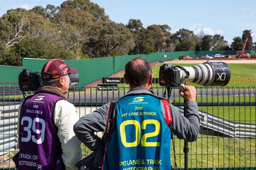 MELBOURNE/AUSTRALIA - SEPTEMBER 17, 2016: Two of the fantastic professional photographers working trackside for the Sandown 500 'Retro' Endurance race at Sandown raceway.