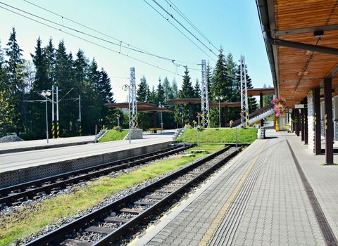 Empty platforms without trains and people at terminal railway station Strbske pleso in High Tatras, Slovakia.