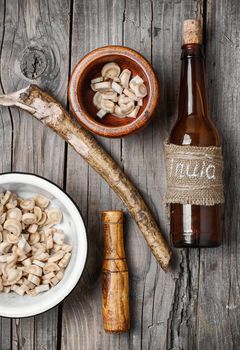 medicinal tincture from the root of elecampane in glass bottle