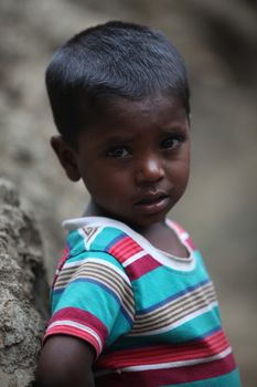 A portrait of a poor little boy from India in his unfortunate condition.