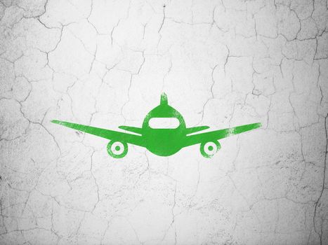 Tourism concept: Green Aircraft on textured concrete wall background
