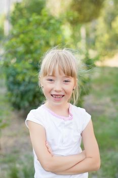 Portrait of the girl in the green bushes, close-up