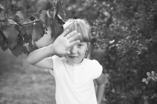 Portrait of the girl in the green bushes, close-up