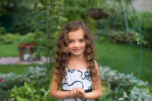 Girl with long hair on nature in a warm summer day