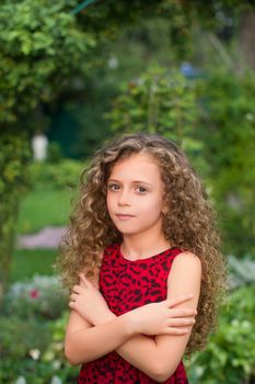 Girl with long hair on nature in a warm summer day