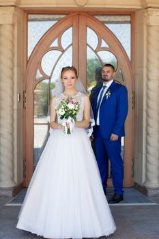 Newlyweds on a walk in a summer day wedding