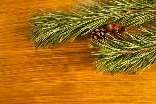 New Year 2017 composition with fir cones and fir tree branch on wooden background