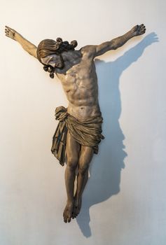 Crucifix of Jesus on the cross with stone background. Symbol of christian religion and belief.