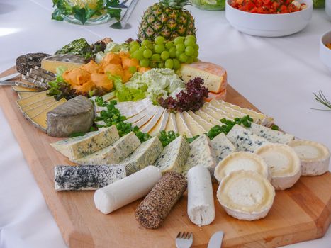 a cheese plate with variety of appetizers on table
