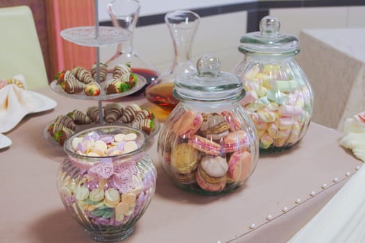 a colorful candies in jars on table
