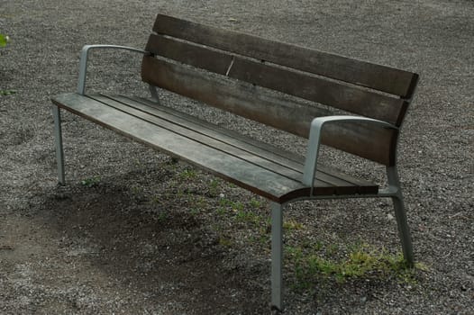 a brown lonely wooden bench in the park