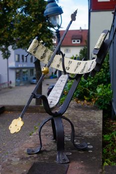 a rustical sun clock outside in a park. Sundial Germany