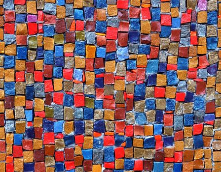 Colorful stone cubes on the wall on full space of photo. Texture.