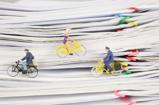 Close up postmen and woman is cycling on pile overload paperwork of report and receipt with colorful paperclip with white background.