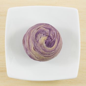 The Taiwanese violet crystal taro cake on the small white square dish.