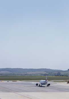 VIENNA, AUSTRIA – APRIL 30th 2016: Plane leaving terminal area on a busy Saturday at Vienna International Airport.