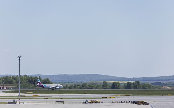 VIENNA, AUSTRIA – APRIL 30th 2016: Plane leaving for taking off on a busy Saturday at Vienna International Airport.