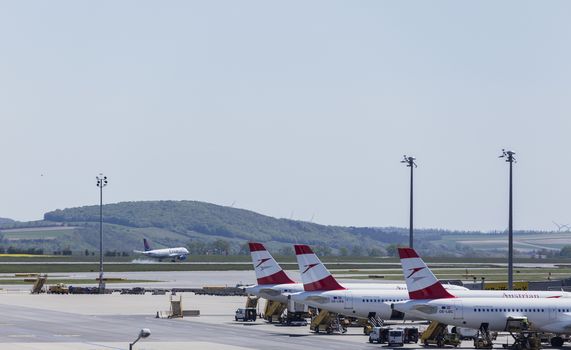 VIENNA, AUSTRIA – APRIL 30th 2016: Austrian Airline planes lined up a busy Saturday at Vienna International Airport.