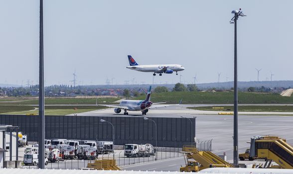 VIENNA, AUSTRIA – APRIL 30th 2016: Plane landing on a busy Saturday at Vienna International Airport.