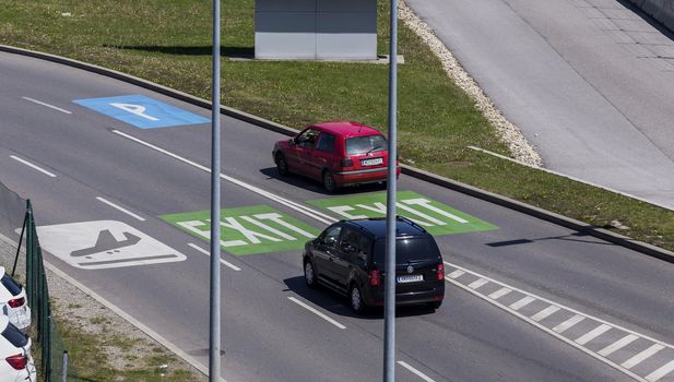 VIENNA, AUSTRIA – APRIL 30th 2016: Cars leaving the parking area at Vienna International Airport on a busy Saturday.