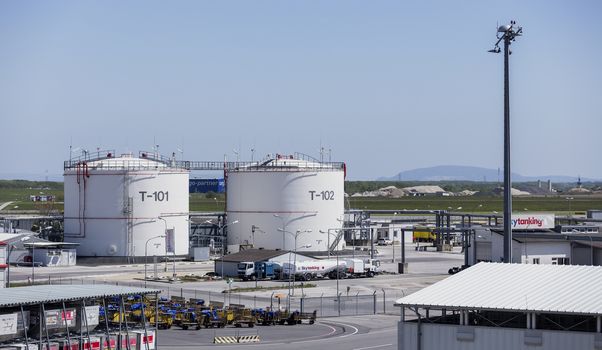 VIENNA, AUSTRIA – APRIL 30th 2016: Fuel storage tanks at Vienna International Airport on a busy Saturday.