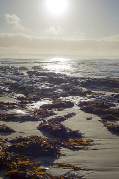 beautiful soft waves break on the rocks on sunset ballybunion beach in ireland