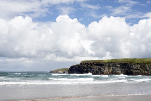 big waves rolling into the cliffs and beach in ballybunion on the wild atlantic way