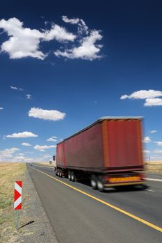 Big transporter truck travelling along the highway at speed