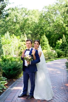 Funny bride and groom on a summer day in the park