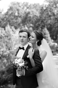 Funny bride and groom on a summer day in the park