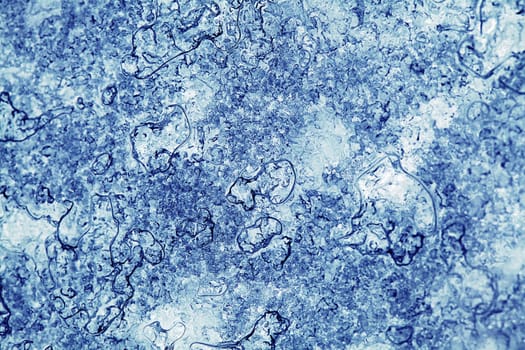 Block of blue smooth melting ice, close-up