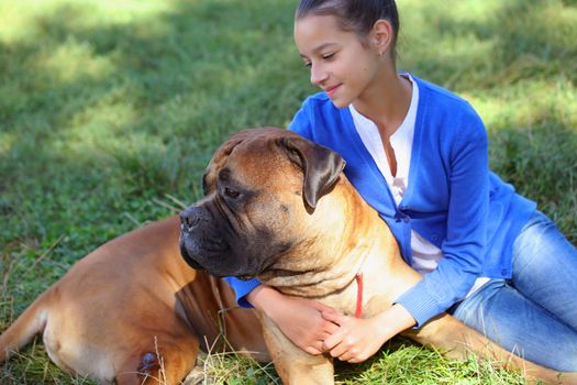 teen girl with the dog Bullmastiff outdoors