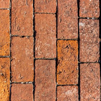 Detailed ancient red brick wall background photo texture.