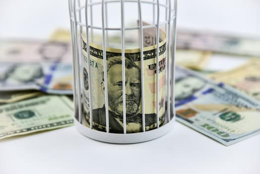 Banknotes trapped inside the cage, behind bars