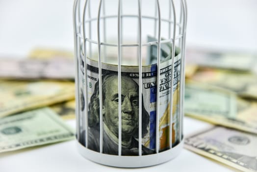 Banknotes trapped inside the cage, behind bars